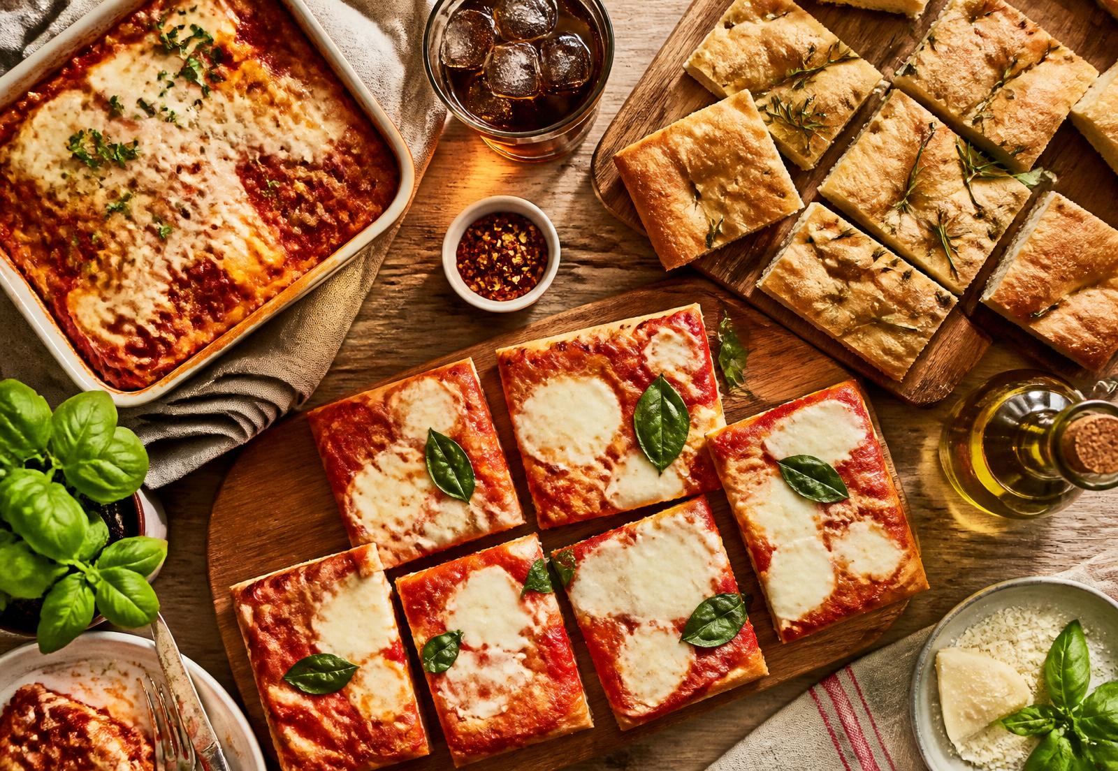 Freshly baked Italian focaccia and square-slice pizza